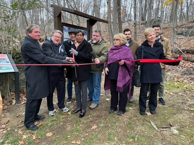 Kevin Marrinan of GDC, Senator Harckham and Mayor McKenzie with scissors, Council members Ramon Fernandez (with hat), Brian Fassett and Kathie Talbot. City Planner Jean Friedman is next Talbot with an architect from MKW Associates behind her and next to city planner Peter Erwin. 