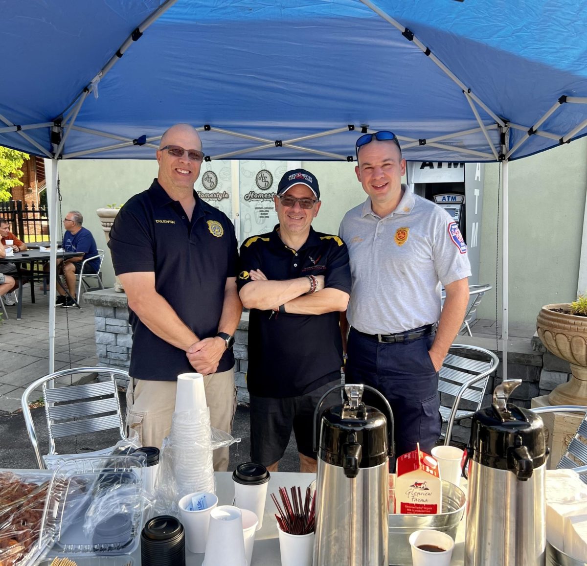 Chief of Peekskill Police Leo Dylewski, left, and Peekskill Fire Chief James Seymour, right, with Basil Kazepis, founder of Westchester Cars and Coffee at last years Coffee with the Chiefs