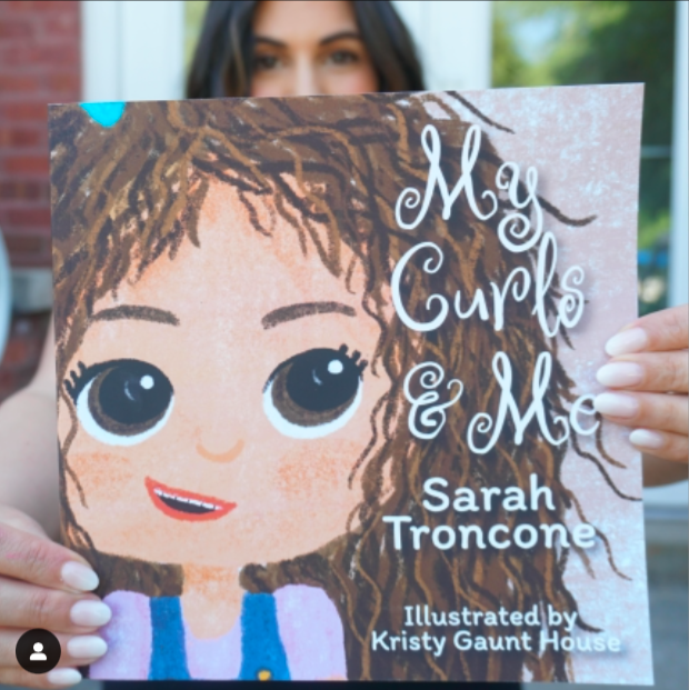 Sarah+Troncone+proudly+holding+her+first+children%E2%80%99s+picture+book+%E2%80%98My+Curls+and+Me%E2%80%99+inspired+by+my+free+spirited+curly+haired+toddler.+