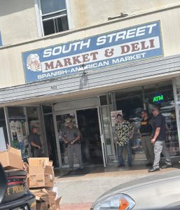 State Troopers and officials from Office of Cannabis Management outside South Street Deli yesterday morning. 