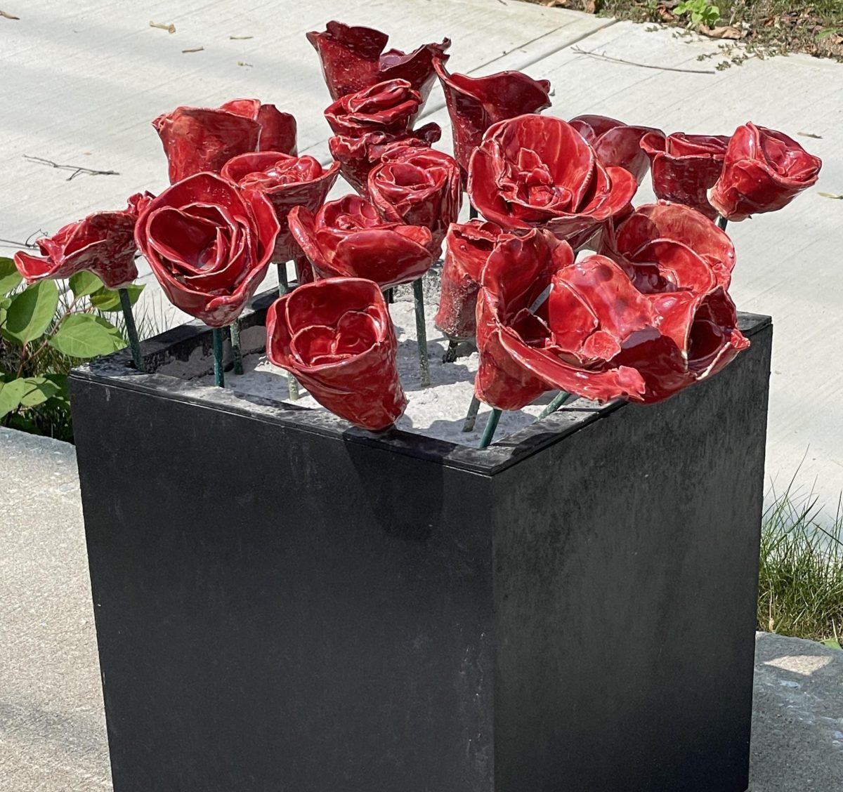 Ceramic roses growing out of concrete