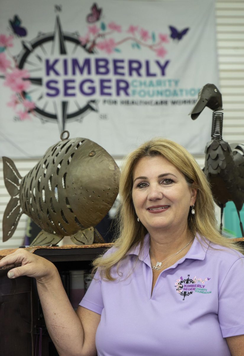 Stacy Seger Murphy with the logo of the foundation her family founded in memory of her sister Kim. 