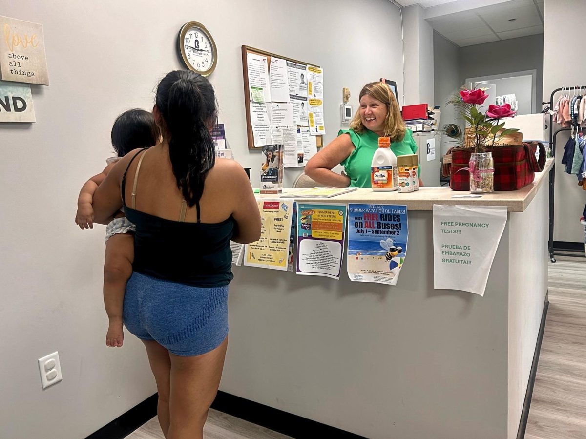 Colleen DiRago greets mothers with a warm smile. Evelyn came to Birthright on the recommendation of a friend.
