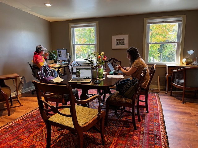 People working in the community space at Kinship Coworking. 