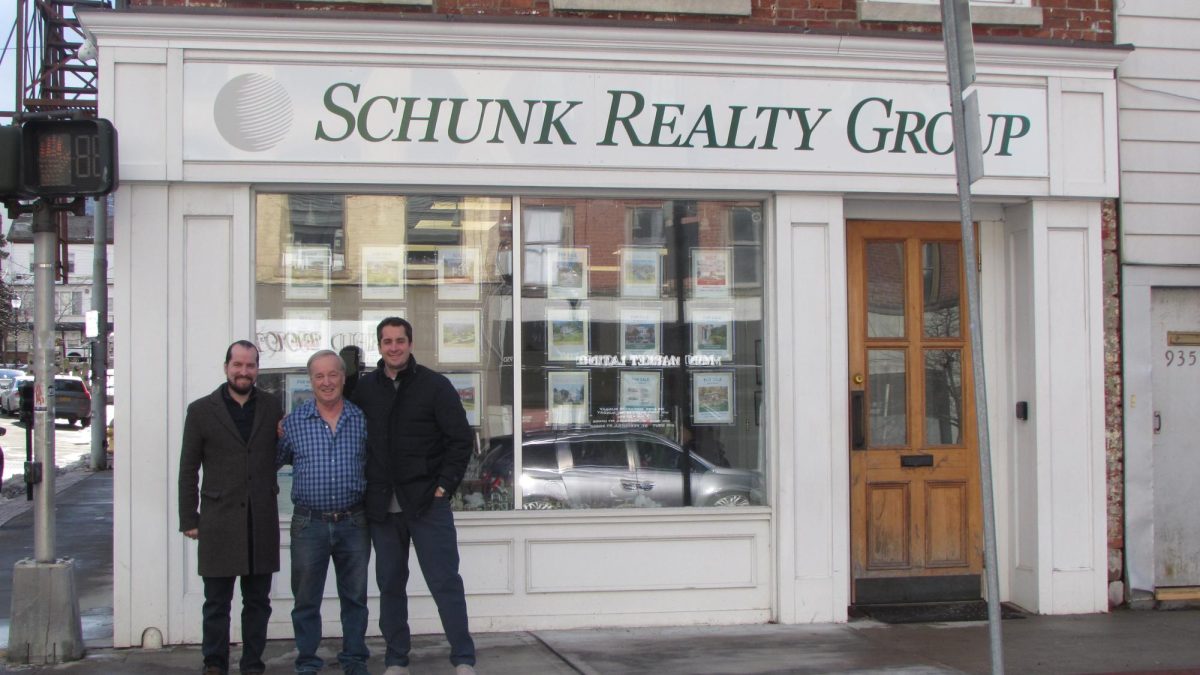 Bill Schunk is flanked by sons Nicholas (left) and James in front of their Peekskill office in the Riley Building at the corner of South and Division streets. Says Bill, 'It's very rewarding to have two sons that are taking over the show.'