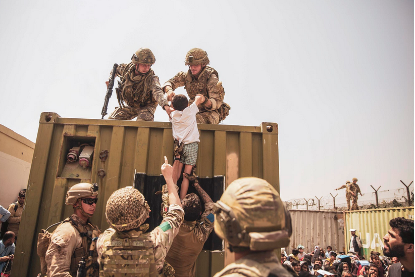 U.S. soldiers rescue an Afghan boy.