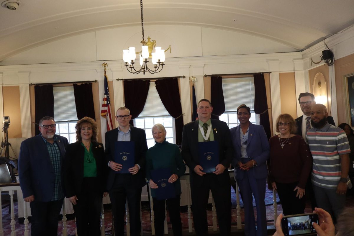 From left, Councilman Brian Fassett, Deputy Mayor Patricia Riley, Trevor Noble, Kathy McGurty, Brian Kelly, Mayor Vivan McKenzie, Councilwoman Kathleen Talbot, City Manager Matthew Alexander, and Councilman Robert Scott. Photo credit: Eric Harvey.