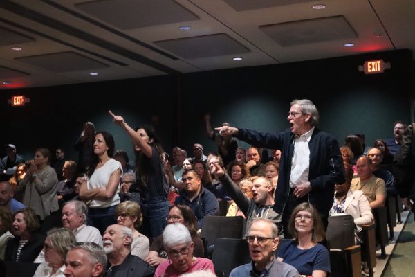 Constituents of U.S. Rep. Mike Lawler point accusatory fingers towards him on stage during his Westchester town hall.