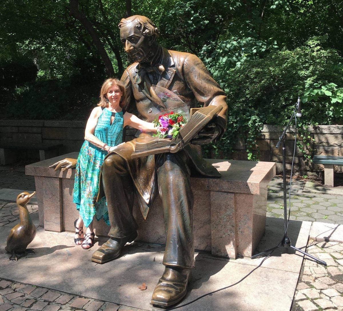 Judith Heineman pays tribute to master storyteller Hans Christian Andersen at statue of him in New York's Central Park.