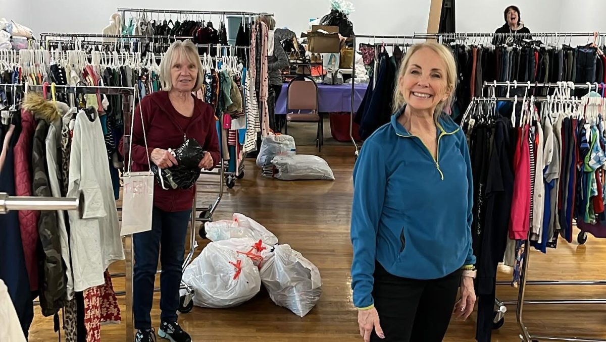 Volunteers sort and arrange donations ahead of the opening. 