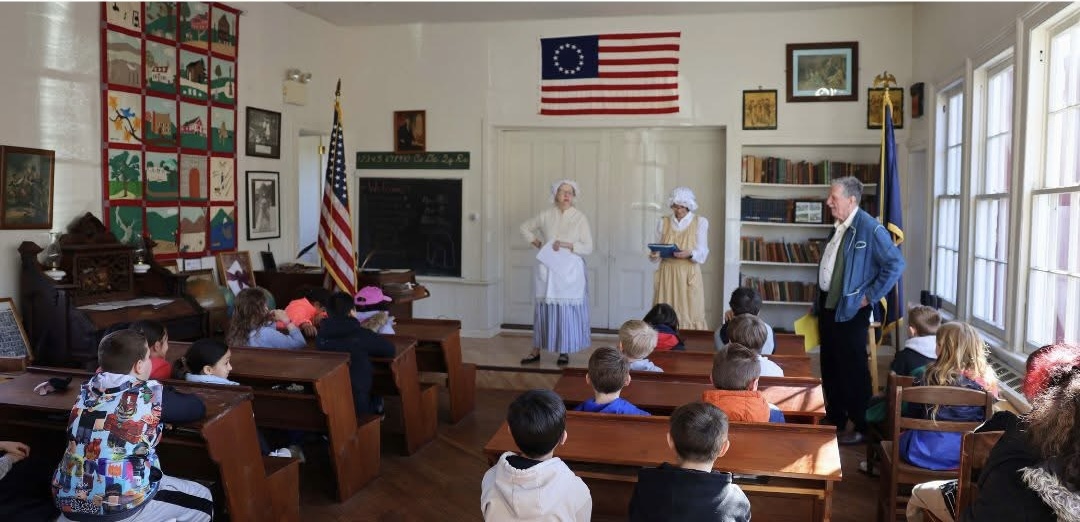 The historical society conducts educational activities, such as programs where elementary school students experience a day of classes at the Little Red Schoolhouse, recreating the school atmosphere of 1840. (Van Cortlandtville Historical Society)]