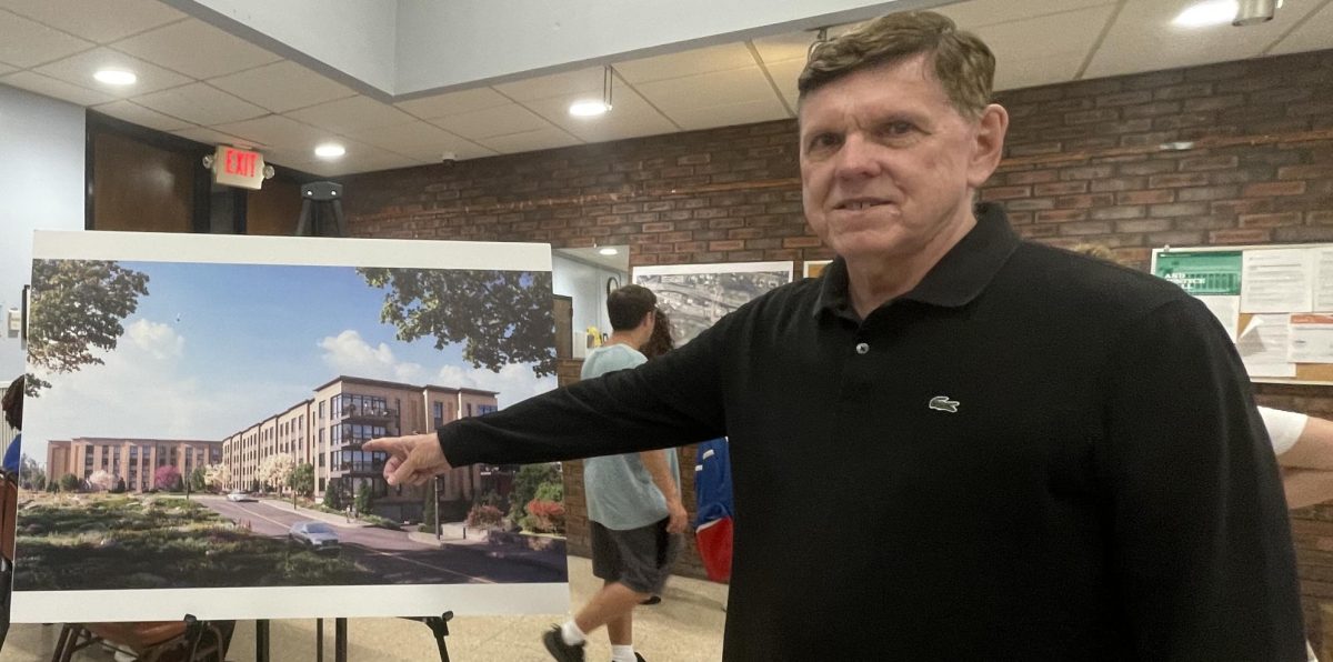 James Surdoval of Ginsburg Development Companies points to rendering of proposed residential development for Railroad Avenue. (Regina Clarkin)
