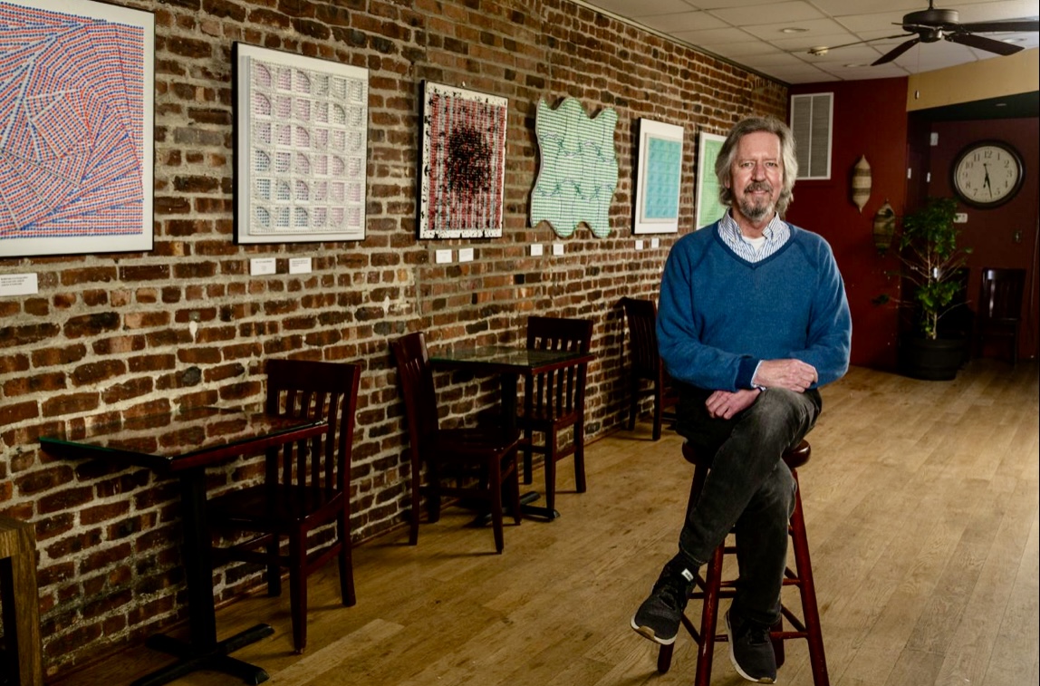 Artist Will Hanlon beside one of his relief works at a previous exhibition at The Bean Runner Gallery. (zhibit.org)