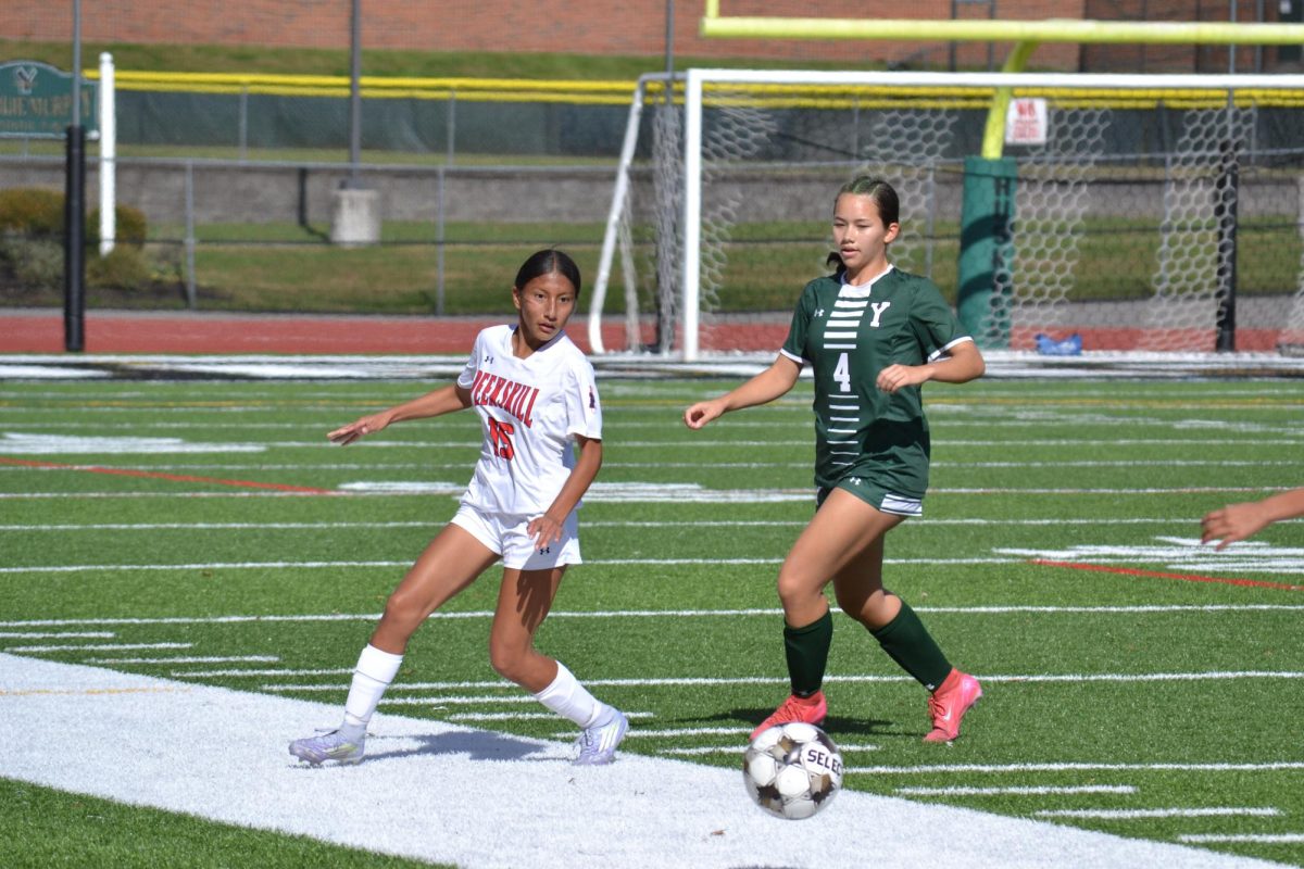 Yorktown defender presses Peekskill forward Brianna Tuba. 
