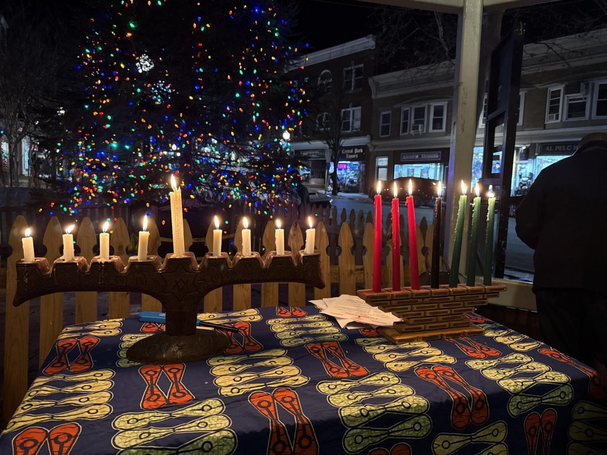 The menorah (left) and the kinara (right) shining bright after the joint candle-lighting ceremony. 