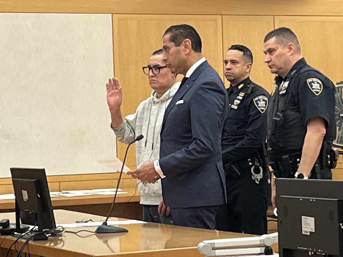 Anselmo Yambay Pena (with his hand up) stands under oath in a paint-stained hoodie beside his attorney, Milton Florez, on Jan. 16. 