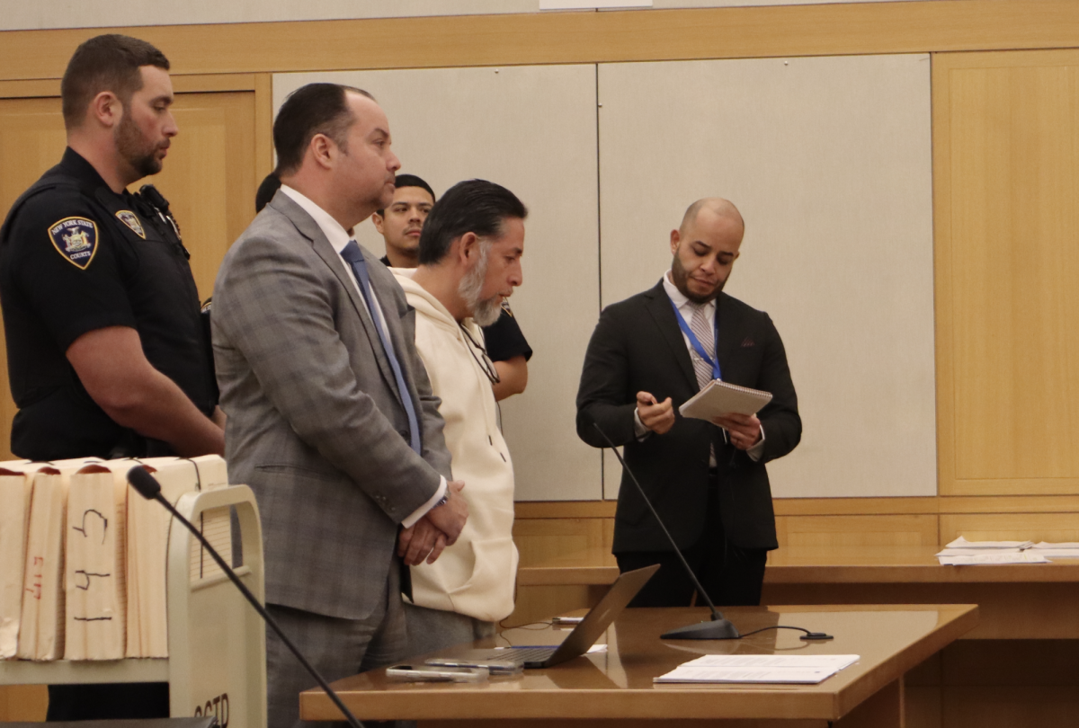 Walter Bustos-Solis (white hoodie) stands at Westchester County Court on Feb. 19. To his left is his attorney, Jeffrey Louis Greco.