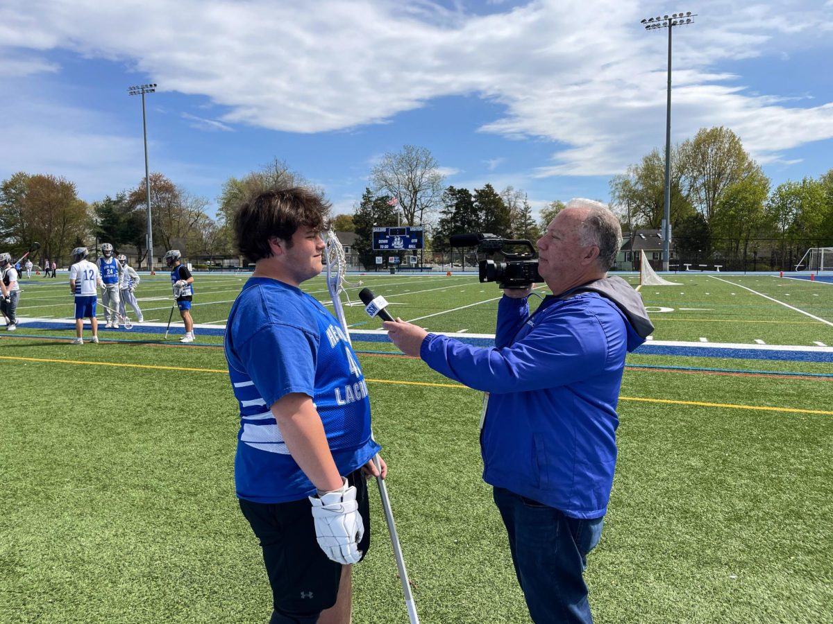 Pete Ruff interviews a Hen Hud boys lacrosse player. (Supplied)