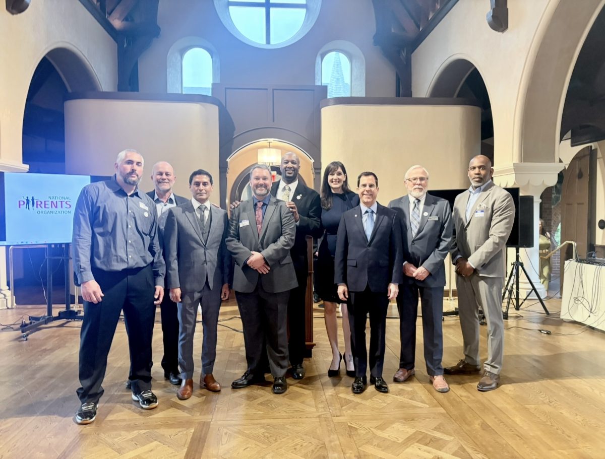 Andre Rainey (center) is flanked by the eight speakers and organizers of the Shared Parenting Conference 2026 following the event in Peekskill, New York.