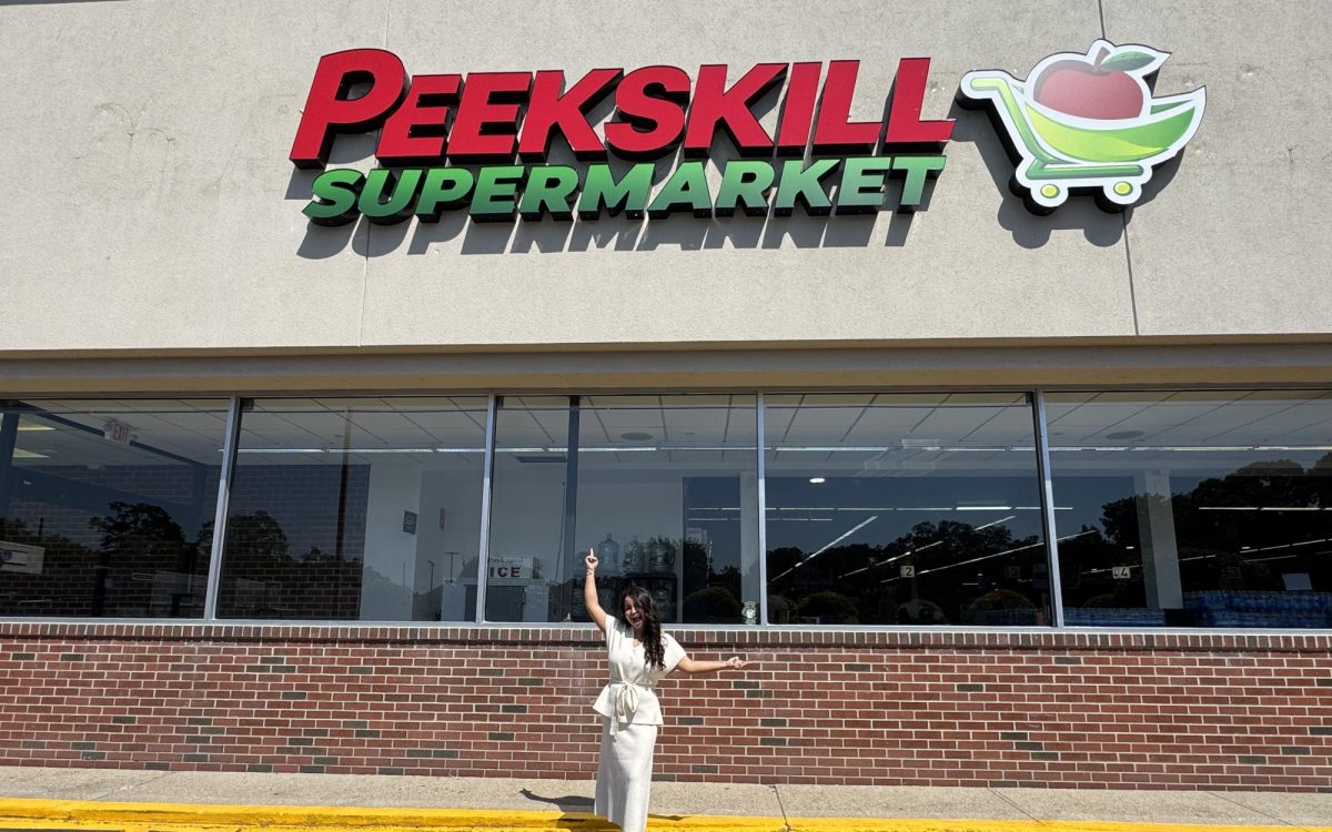 CEO Karina Zeor in front of Peekskill Supermarket storefront on Welcher Avenue.