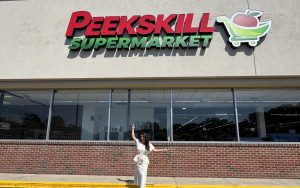 CEO Karina Zeor in front of Peekskill Supermarket storefront on Welcher Avenue.